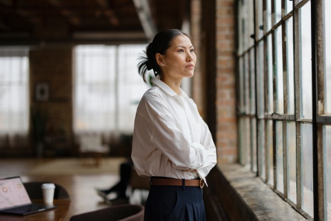 HR leader standing by an office window