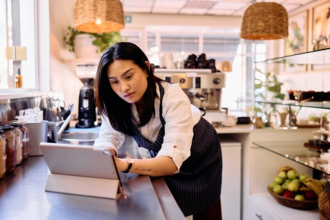 Small business owner reading up on international payroll costs