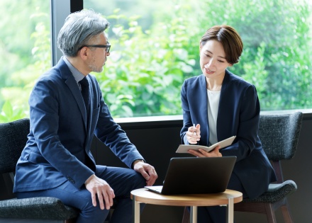 Executives discussing implementing a pay for performance model