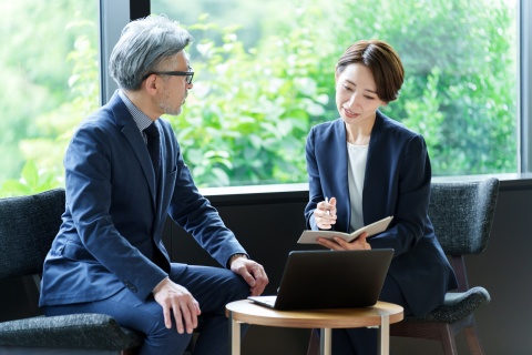 Executives discussing implementing a pay for performance model