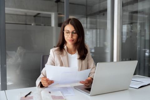 Businesswoman reading about payroll tax in Chile