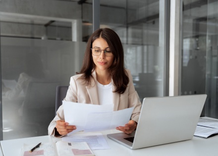 Businesswoman reading about payroll tax in Chile