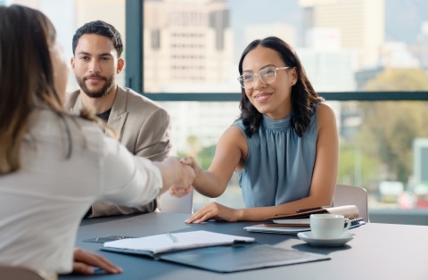 Businesswoman shaking hands after discussing salary in Latin America