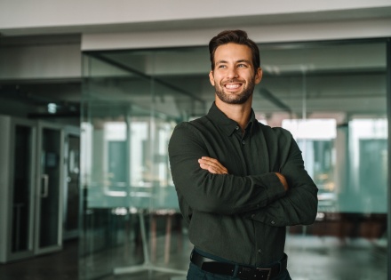 Businessman standing crossed arms in office in Moldova
