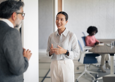 Businesswoman talking with colleague about payroll taxes in Sri Lanka