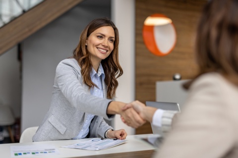 Businesswoman shaking hands after discussing salary in Lebanon