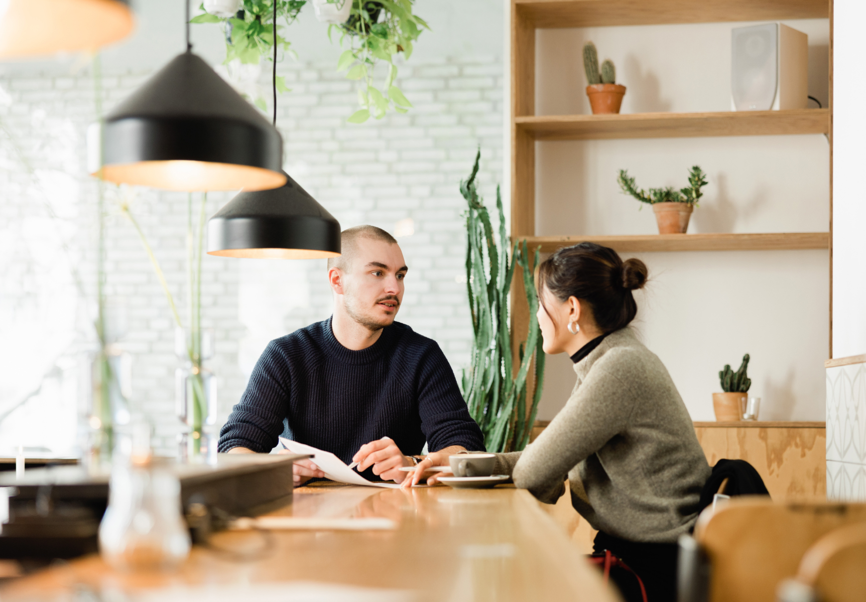 Two co-workers collaborating on a project in a co-working space