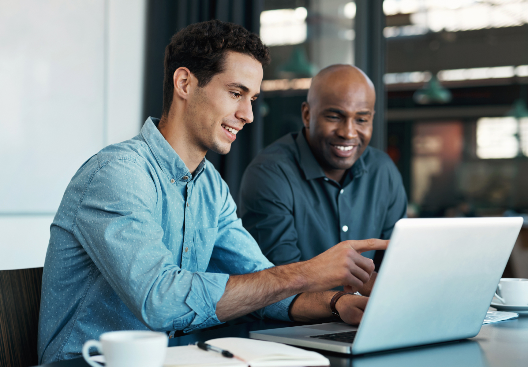 Two co-workers collaborating on a task in a co-working space