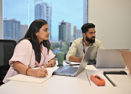 HR employees discussing using an EOR vs staffing agency