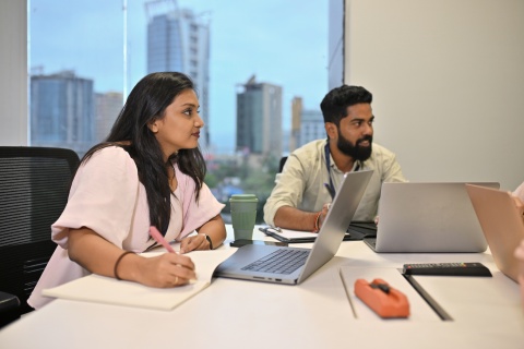 HR employees discussing using an EOR vs staffing agency