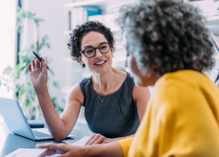  HR team members discussing how to get work authorization in Belgium