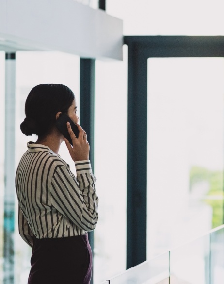 Global HR team member managing global contractors on her phone
