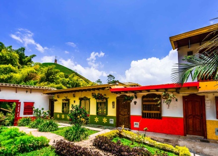 Photo of beautifully colored buildings in the green hills of Colombia