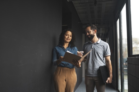 Global HR team members discussing how to hire AI engineers