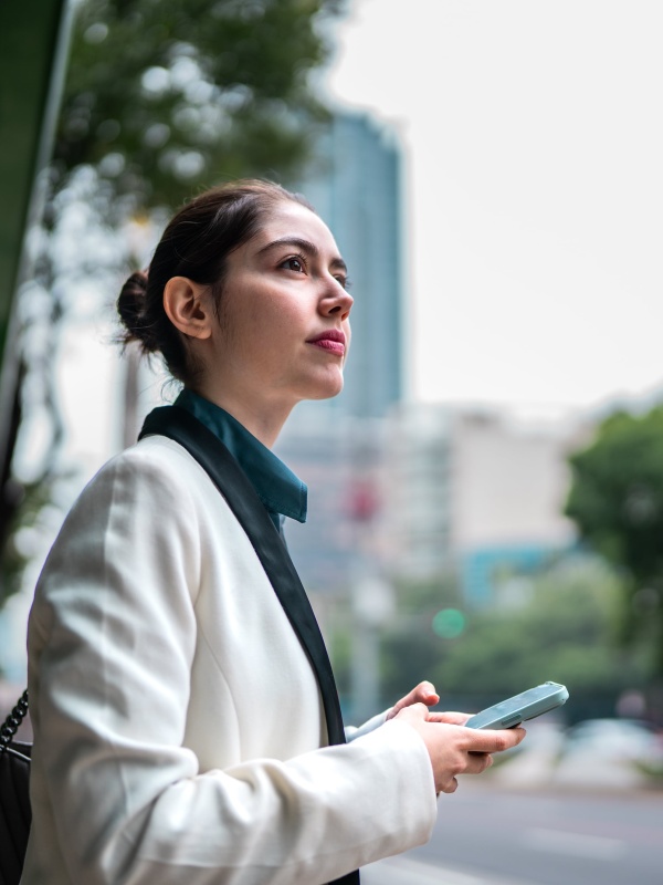 Woman crossing the street while considering EOR services in Mexico.