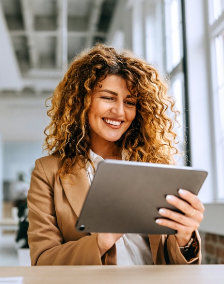 Woman reviewing global compliance strategy on tablet