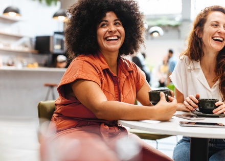 HR team laughing while learning about employee benefits trends