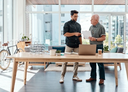 Two man talking about a project with laptop