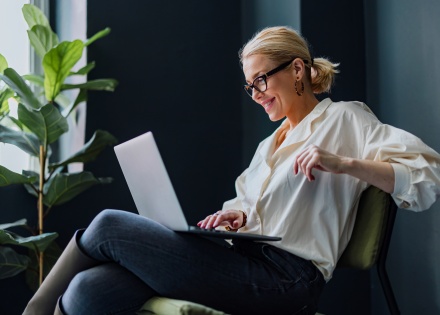 Woman smiling at laptop