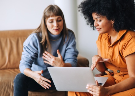 Two HR leaders discussing their strategy for hiring foreign workers 