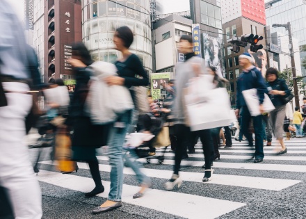 People crossing road in a busy intersection in Japan
