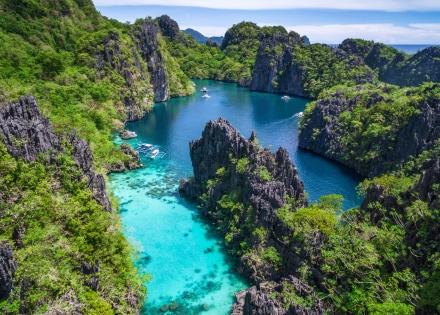 Kayangan Lake in Coron, Palawan, Philippines, surrounded by green islets and mountains