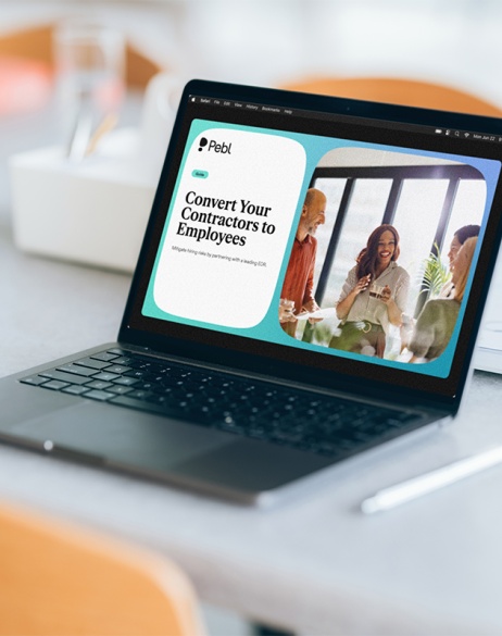 Laptop on desk displaying Convert Your Contractors to Employees guide.