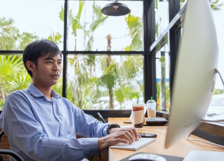 Asian businessman working at a coffee shop.