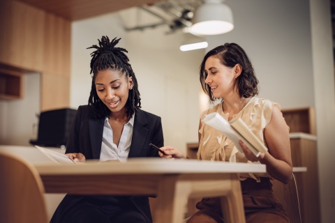 Two colleagues discuss their research on Philippines work visas