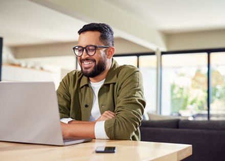 Global HR manager smiling while reading about Guinean work visas