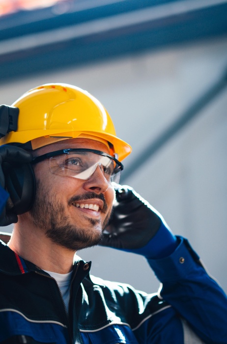 Man in construction zone with hard hat and safety glasses.