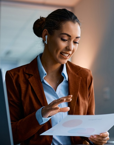 Woman talking on the phone while holding business paper