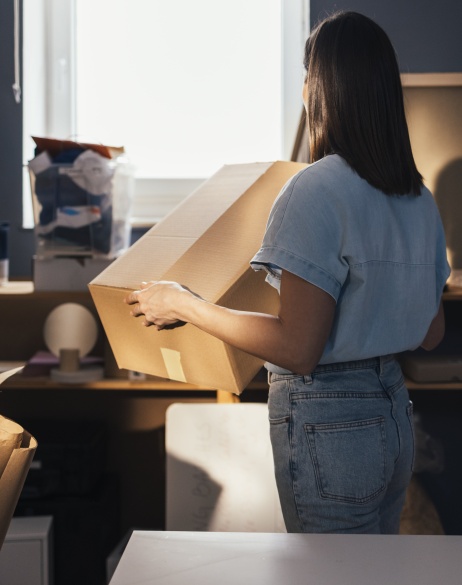 Small business retail owner unpacking boxes after using Pebl EOR for global expansion.