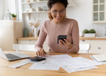 Smiling young woman looking at her cellphone