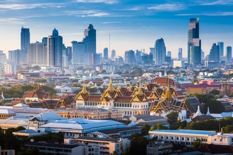 Grand Palace and skyscrapers at dawn in Bangkok, Thailand