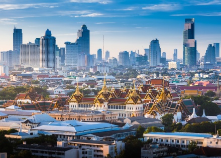 Grand Palace and skyscrapers at dawn in Bangkok, Thailand
