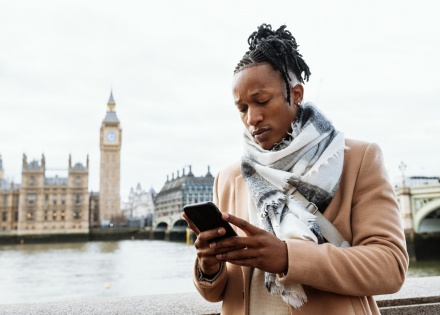 Man working remotely on his smartphone near Big Ben in London, England
