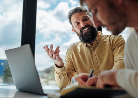 Two businessmen having a meeting about payroll taxes in Pakistan