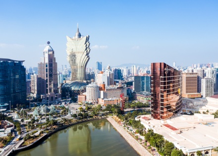 Urban landscape of Macau with the famous traveling tower under a blue sky