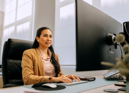 Well-dressed businessman working on a desktop PC