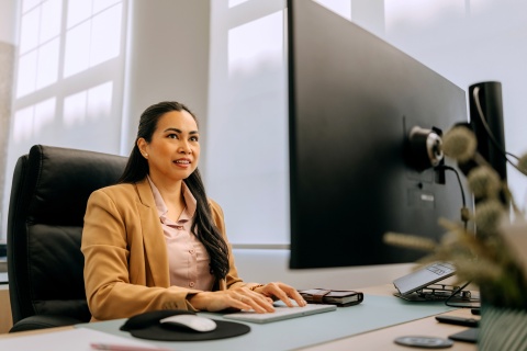 Well-dressed businessman working on a desktop PC