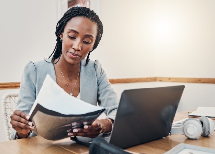 Woman at her desk looking at payroll taxes in Bhutan