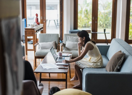 HR manager going through an HR compliance checklist on her laptop