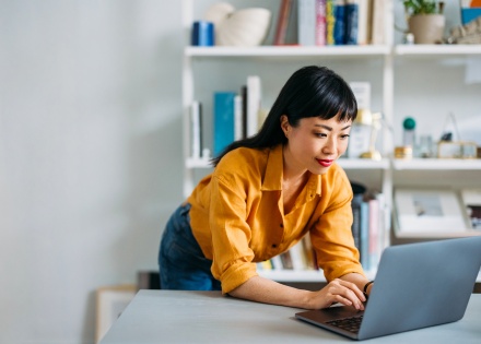 CEO standing at her desk overcoming small business challenges