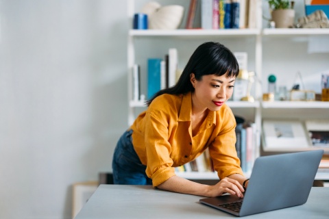 CEO standing at her desk overcoming small business challenges