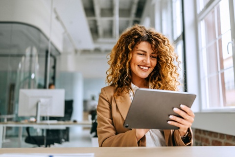 Young cheerful businesswoman working on a digital tablet in Turkmenistan