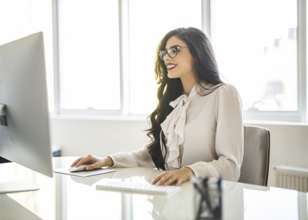 Young woman working on a computer in her office