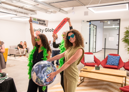 Pebl team members pose with photo booth props.