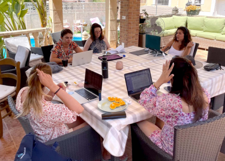Pebl colleagues working poolside at the Co-Work World Retreat