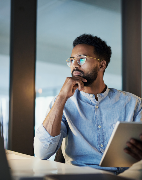 Man holding notebook looking at computer